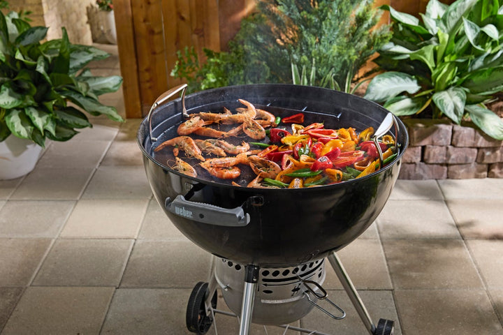 Weber Griddle cooking shrimp on a Master-touch Weber kettle