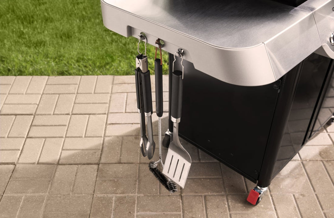 Tool hooks on the Weber Genesis E-315 with tools hanging from them