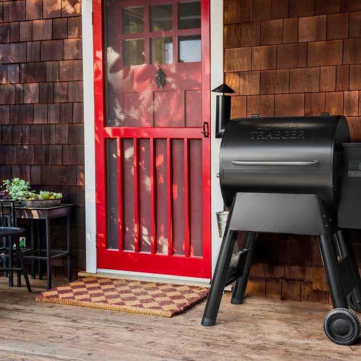 Traeger Pro 575 Smoker Grill om a patio by a front door